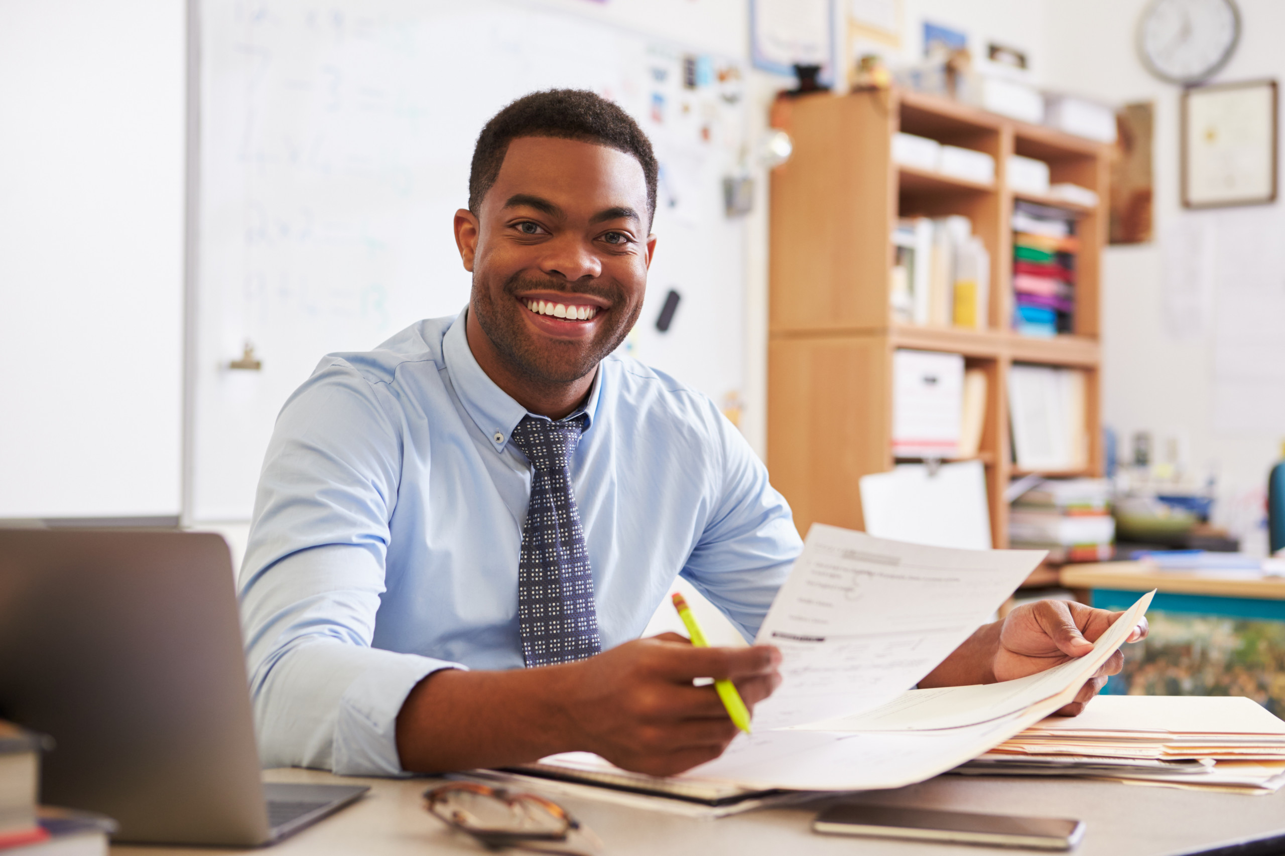 Portrait of African American male teacher working at desk