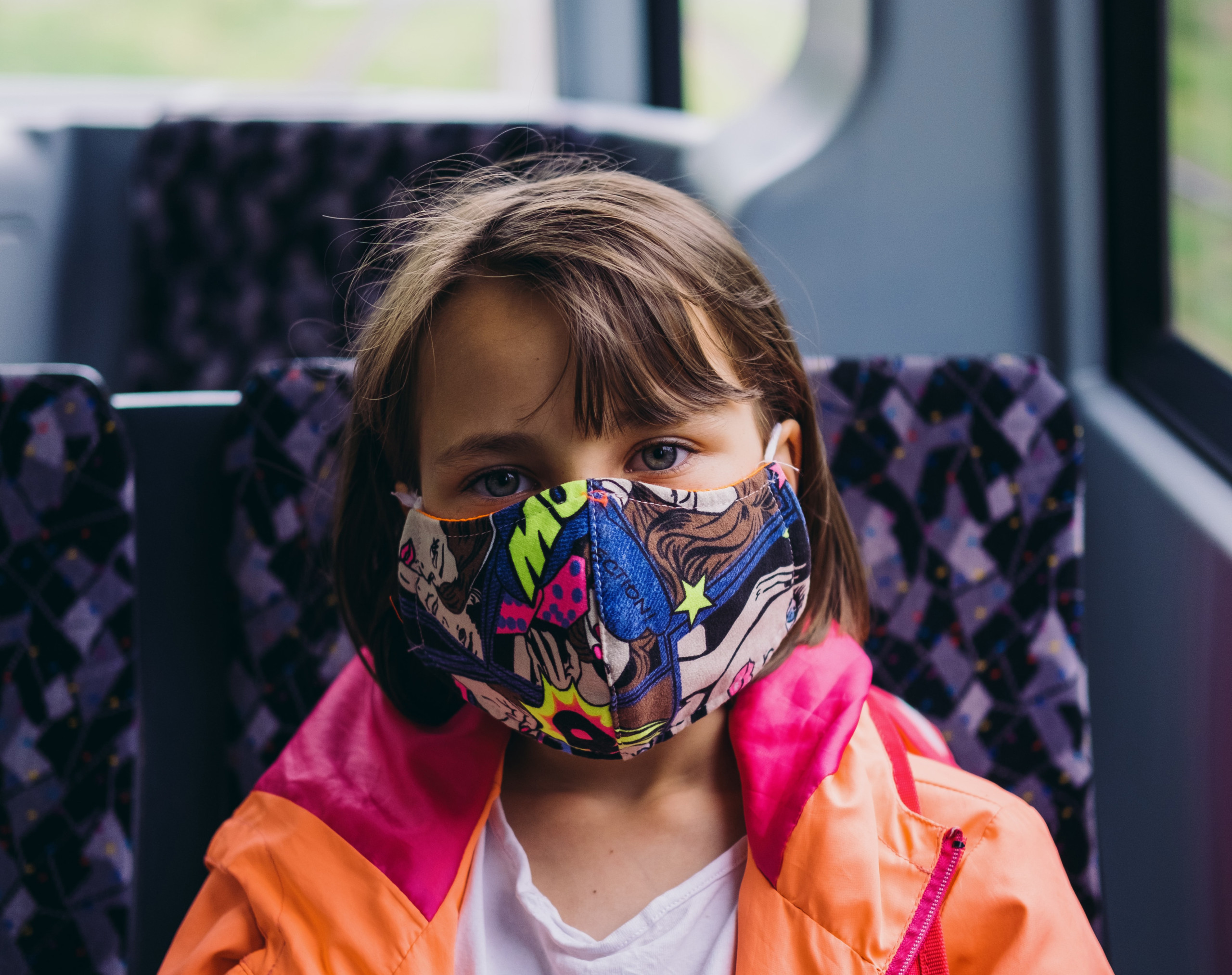 Child on School Bus Wearing Mask