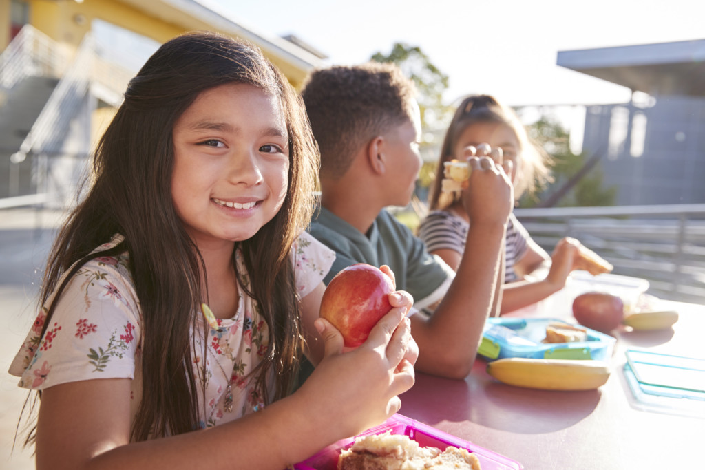 Girl Smiling at Lunch