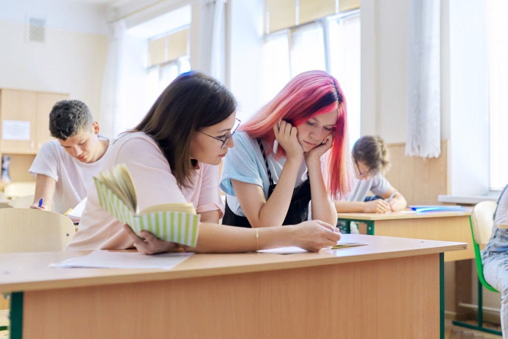 Teacher helping student