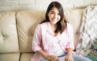 Girl Using Laptop at Home