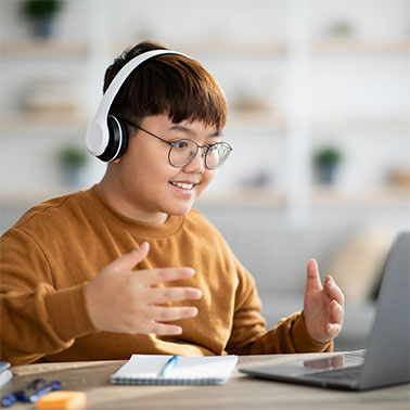 Boy wearing headphones and laptop